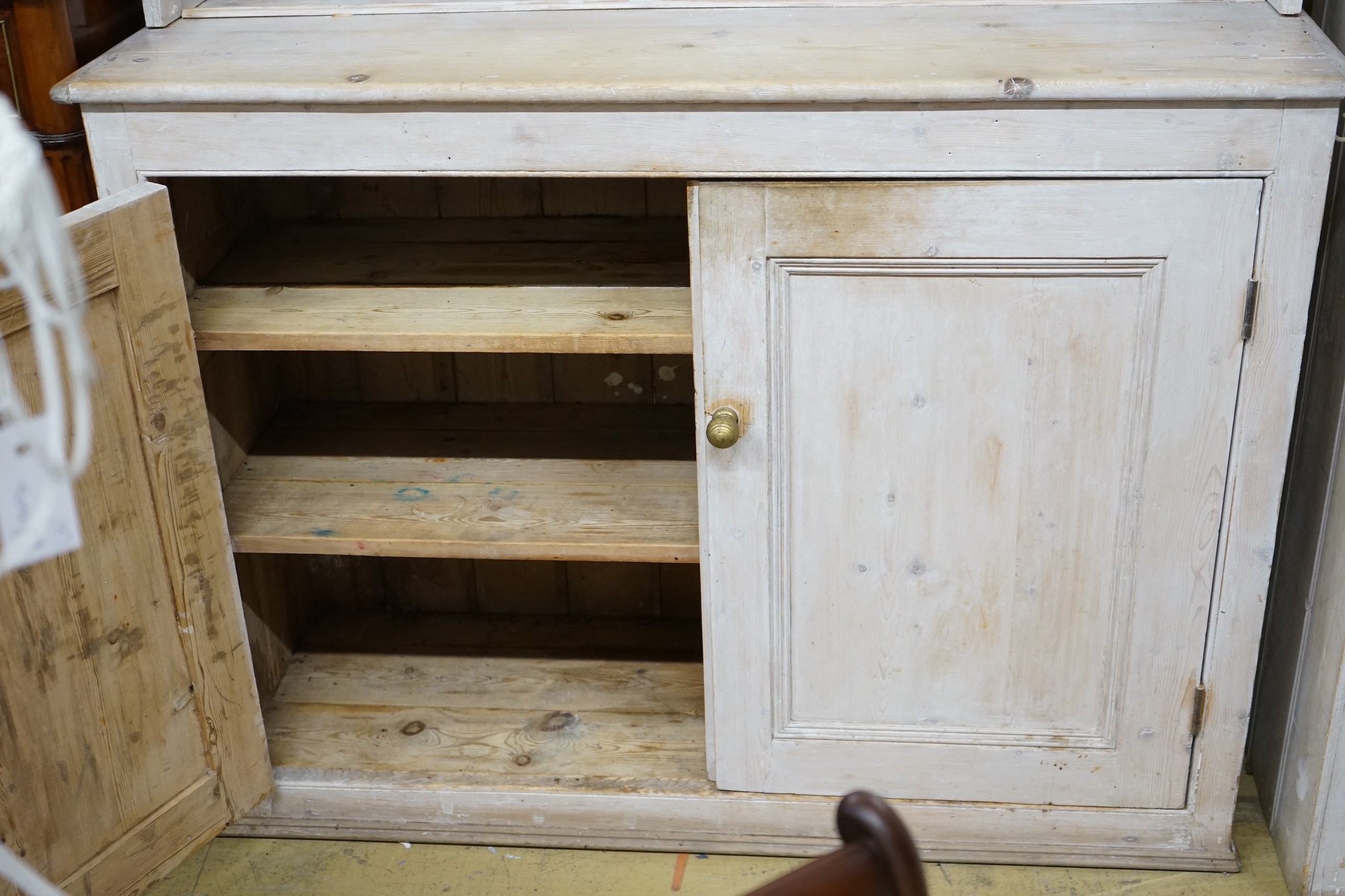 A Victorian painted pine dresser with later boarded rack, length 125cm, depth 42cm, height 215cm